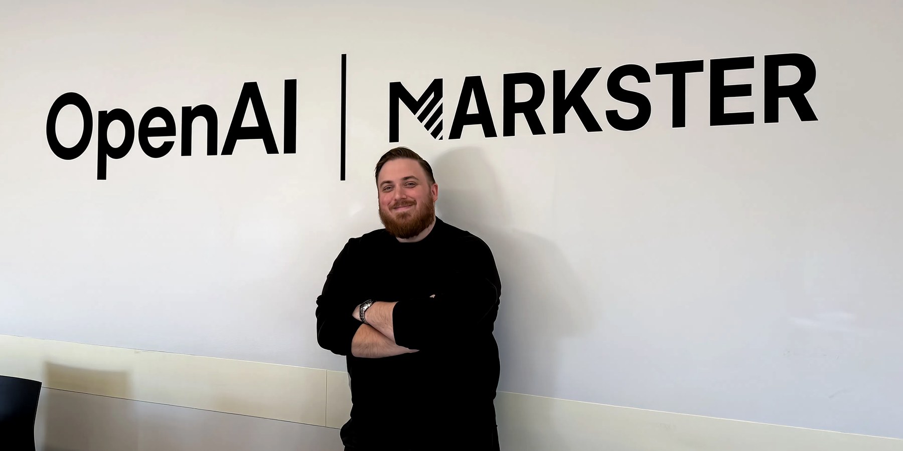 Ivan Ivanka, Founder and CEO of Markster, standing beside an OpenAI and Markster wall lockup