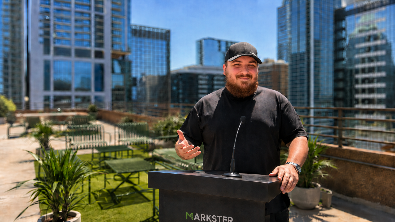 Ivan Ivanka standing behind a Markster lectern on a terrace overlooking downtown Austin